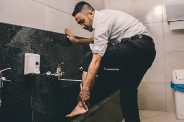 Muslim cleaning his legs before the prayer