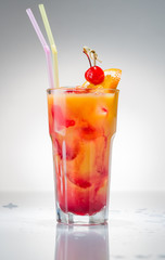 Cocktail with orange juice and ice cubes on white background