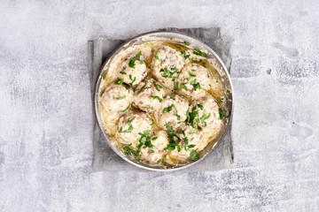 Meatballs with white sauce and green herbs