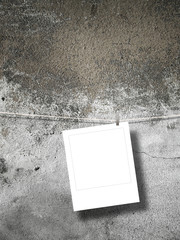 Blank square photo frame on weathered concrete wall background