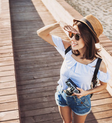 Young beautiful woman photographer taking images with camera