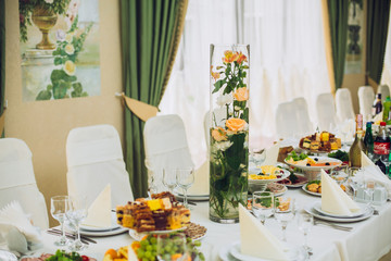 table set service with silverware and glass stemware at restaurant before party