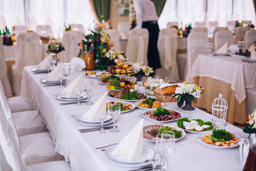 table set service with silverware and glass stemware at restaurant before party