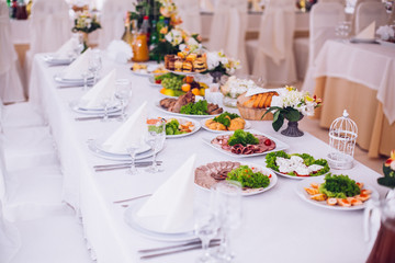 table set service with silverware and glass stemware at restaurant before party
