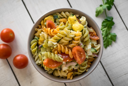 Healthy Sicilian salad. Pasta with raw vegetables and cheese. Top view.