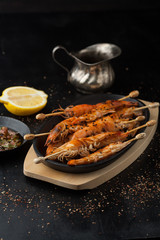 Delicious grilled shrimp with lemon, spices and sauce