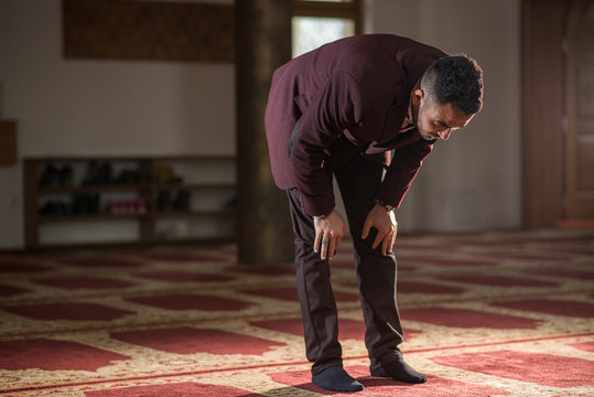 Muslim bowing down in prayer to God