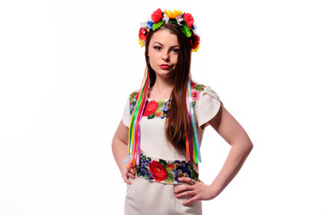 Girl in Ukrainian national traditional costume holding her flower chaplet - isolated on white