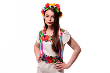 Girl in Ukrainian national traditional costume holding her flower chaplet - isolated on white
