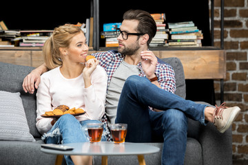 Couple drinking tea with biscuits