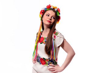 Fototapeta na wymiar Girl in Ukrainian national traditional costume holding her flower chaplet - isolated on white