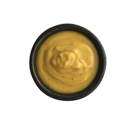 Mustard Sauce in Round Black Bowl Isolated on White Background