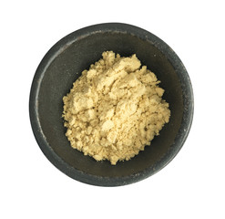 Mustard Powder in Round Black Bowl Isolated on White Background