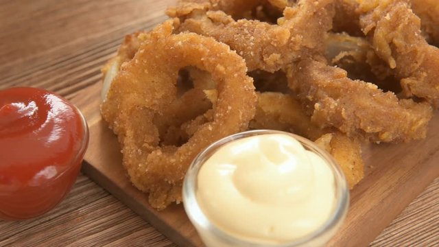 Fresh onion gings on a wooden board