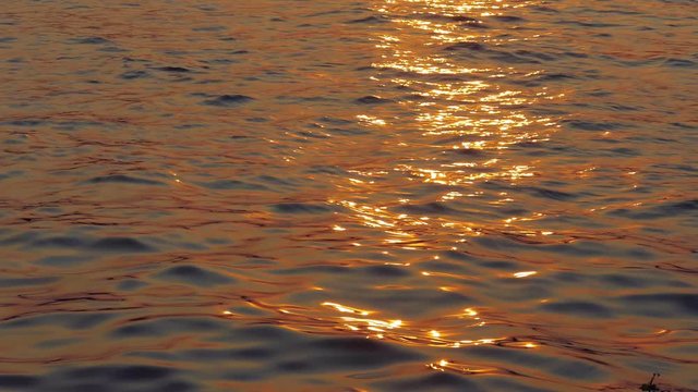 Sunlight reflected on the surface at the time of sunset. The waves on the surface moving very romantic and beautiful : Ultra HD 4K High quality footage size (3840x2160)