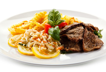 Roasted steak with french fries and vegetable salad