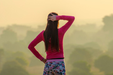 healthy woman stretch arms with sunrise view in morning.