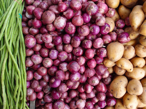 Potato, onion and beans on shop's display. Long beans, red onion and golden potato composition.