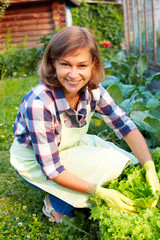 Beautiful young woman taking care of the garden