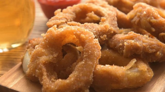 Fresh onion gings on a wooden board