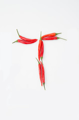 Obraz na płótnie Canvas Bold letter T Latin alphabet of red hot chili pepper on a white background