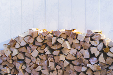 plenty of firewood stacked next to the wall.