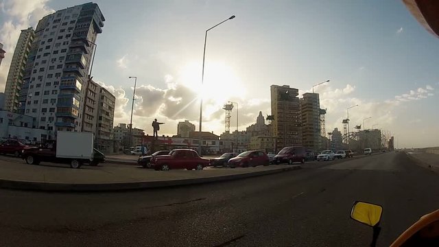Driving motorbike in a city at the evening