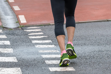 legs of a man running on the street