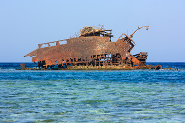 Rusting metal shipwreck on a coral reef