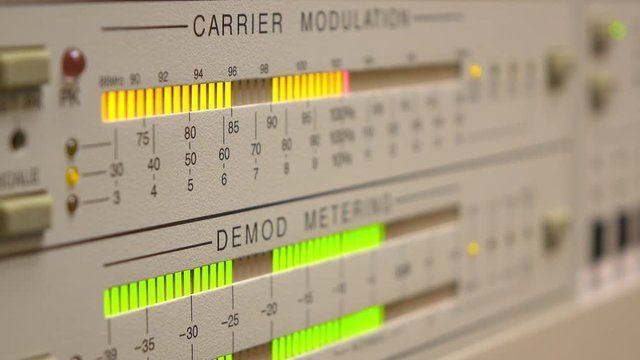 Electronic control board at radio station showing signal levels.
