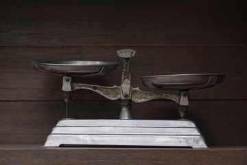 Scales / View of old scales on dirty wooden shelf. Dark tone. Shallow depth of field.
