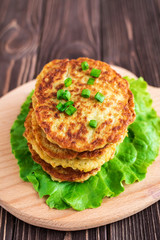 Fried potato pancakes on wooden background