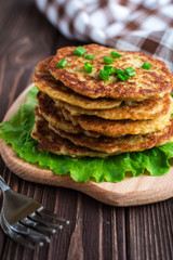 Fried potato pancakes on wooden background