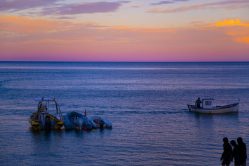 Beautiful cnad colorful pink, purple, blue and violet horizon sunset from the beach