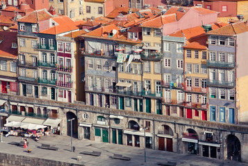 Porto embankment with cafes and shops at sunrise. Classical portuguese architecture. Touristic route. Portuguese real estate.