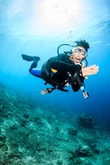 Papier Peint photo Plonger Happy SCUBA diver on a coral reef