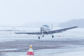 Small plane at the airport in winter