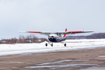 Small plane at the airport in winter