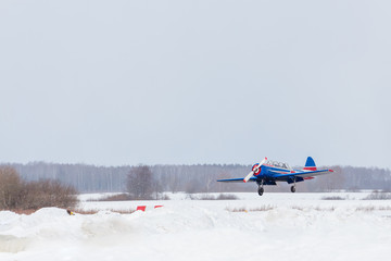 Small plane at the airport in winter