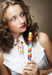 curly  girl with a lollipop in her hand 