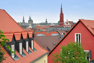 Fototapeta premium Panorama of Wurzburg with ancient towers of churches. Pitched tiled roof in the foreground. Bavaria, Germany.