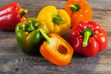 Fotobehang  Fresh colored bell pepper on wooden background © Shmel