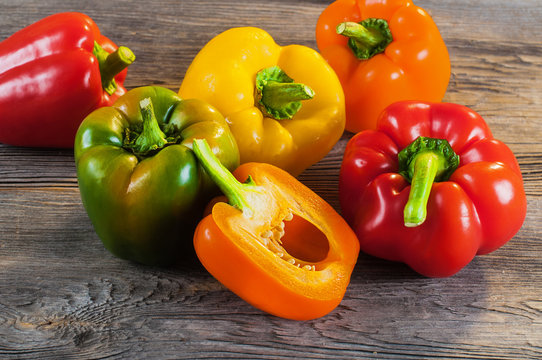  Fresh colored bell pepper on wooden background