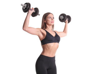 sporty muscular woman working out with dumbbells