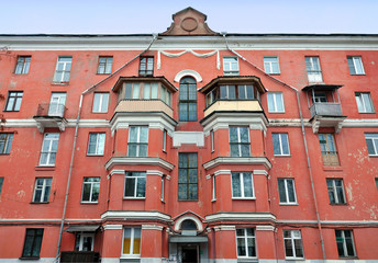Fototapeta premium Ancient red brick building with bay windows, balconies and gutters on the street of Minsk, Belarus