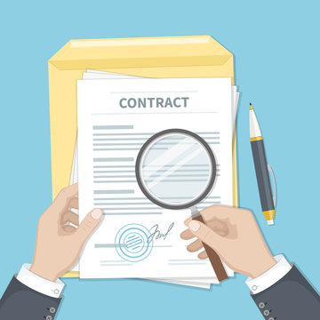 Contract inspection concept. Businessman hands holding magnifying glass over a contract. Contract with signature and stamp. Research documents.