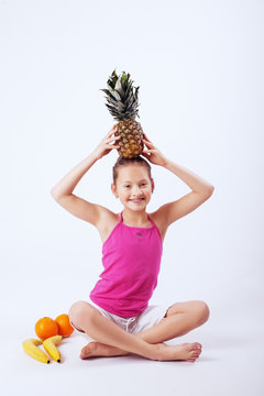 Funny Child Has Oranges, Pineapple And Banana. The Concept Of Healthy Eating And Vegetarianism.