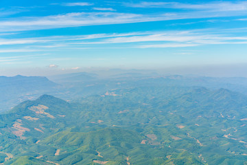 Mountains under clouds. View from the airplane .