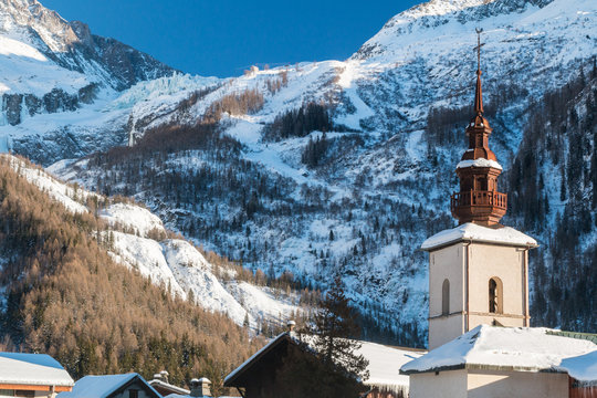 Argentiere Church in the centre of Argentiere village in winter.  The argentiere glacier in behind the village.