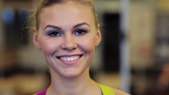 happy smiling young woman at gym